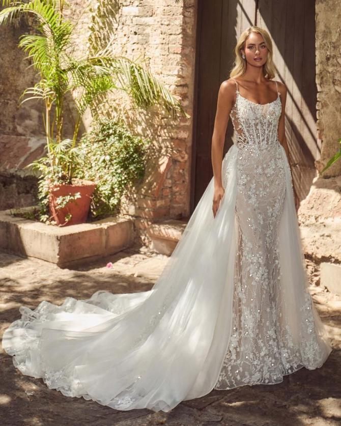 a woman in a wedding dress standing outside