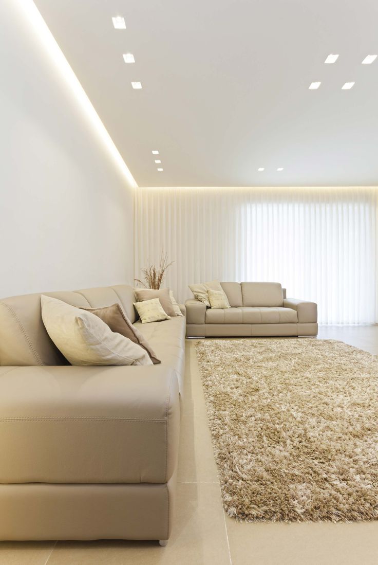 a modern living room with white walls and carpet