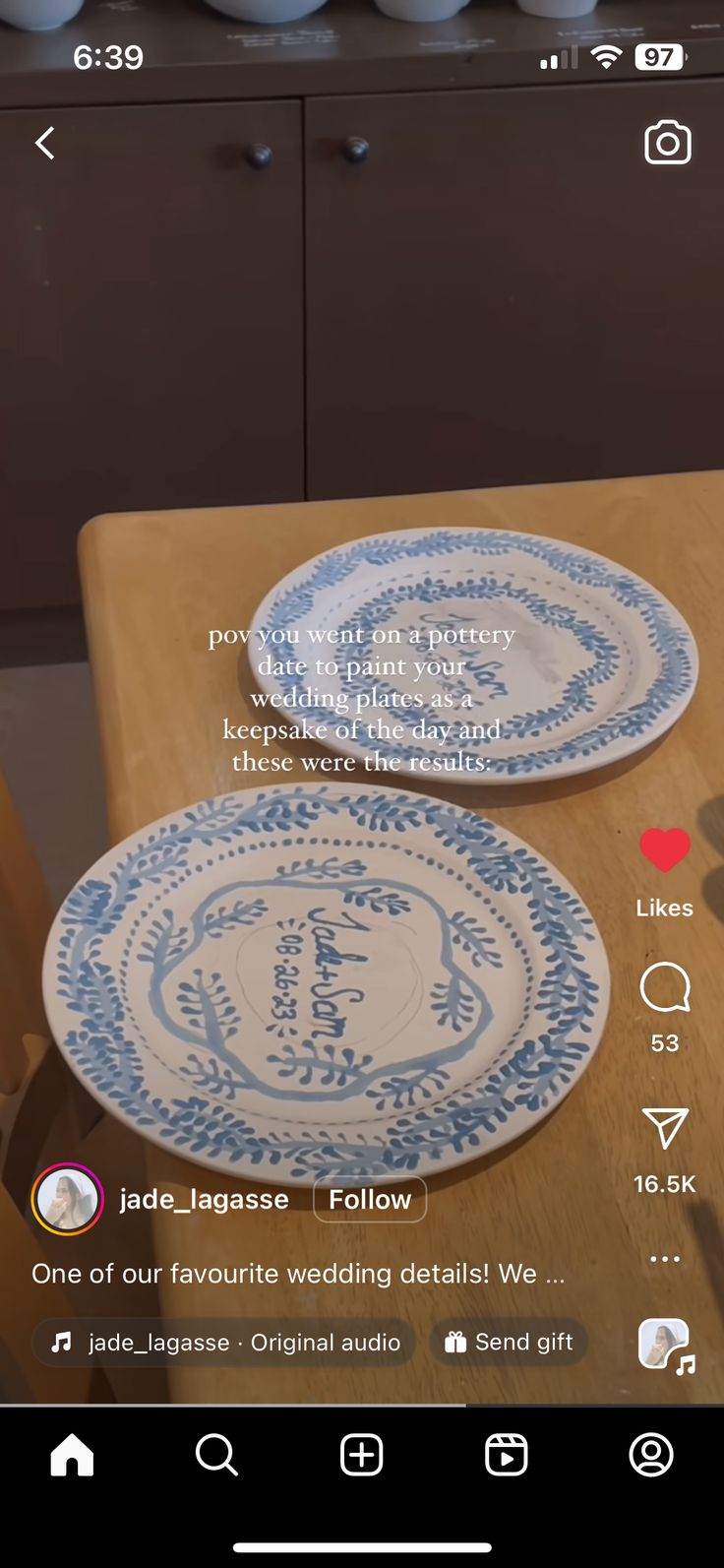 two blue and white plates sitting on top of a wooden table next to each other