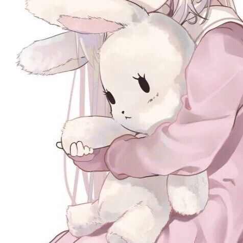 a girl hugging a white bunny in her arms