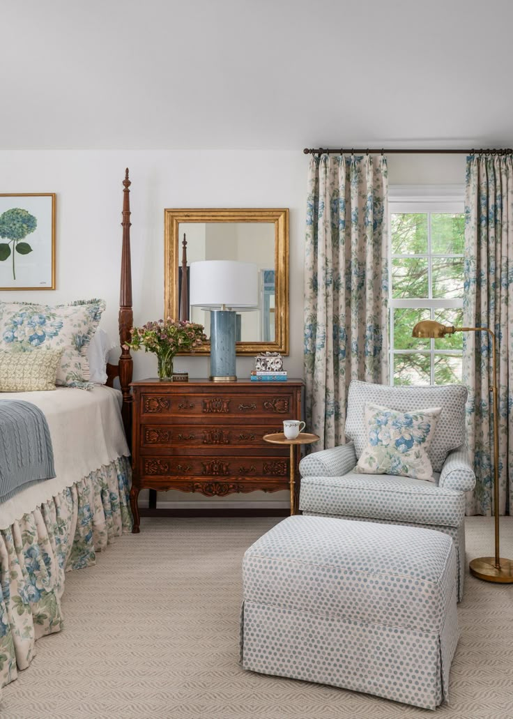 a bed room with a neatly made bed next to a chair and a dresser in front of a window