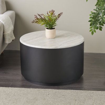 a white and black table with a potted plant on it next to a couch