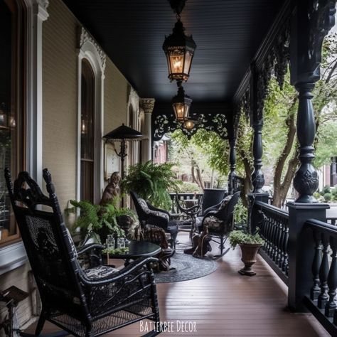 a porch with chairs and plants on the side walk next to an iron lamp post