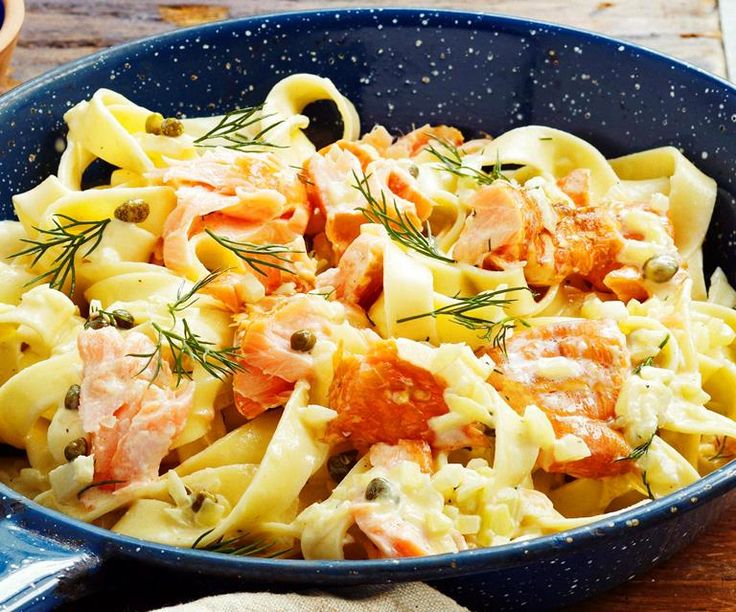 pasta with salmon and capers in a blue bowl