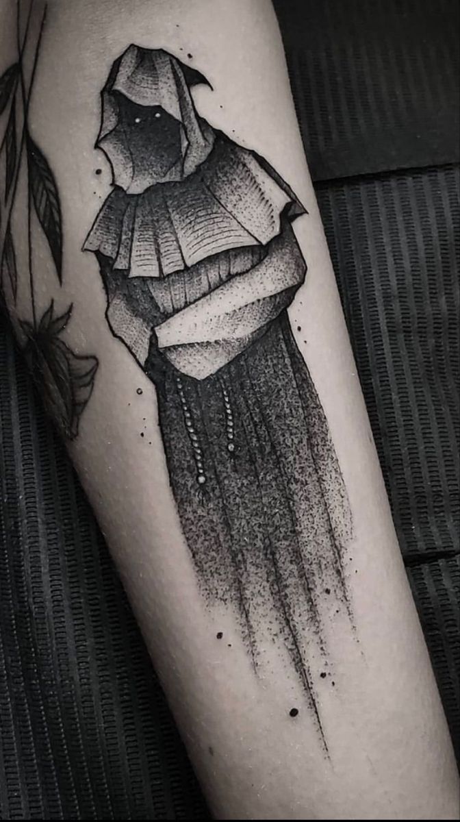 a black and white photo of a person's leg with a tattoo on it