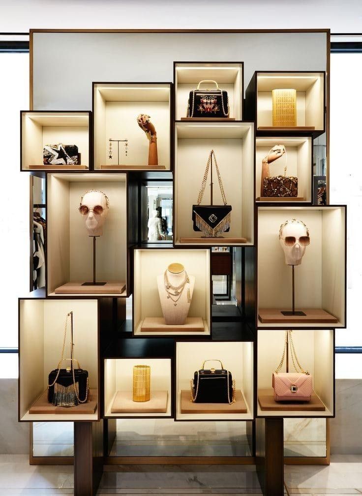 a display case filled with lots of purses and handbags on top of wooden shelves