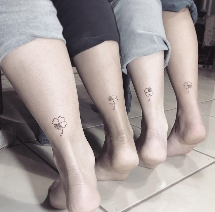 three people with matching tattoos on their legs