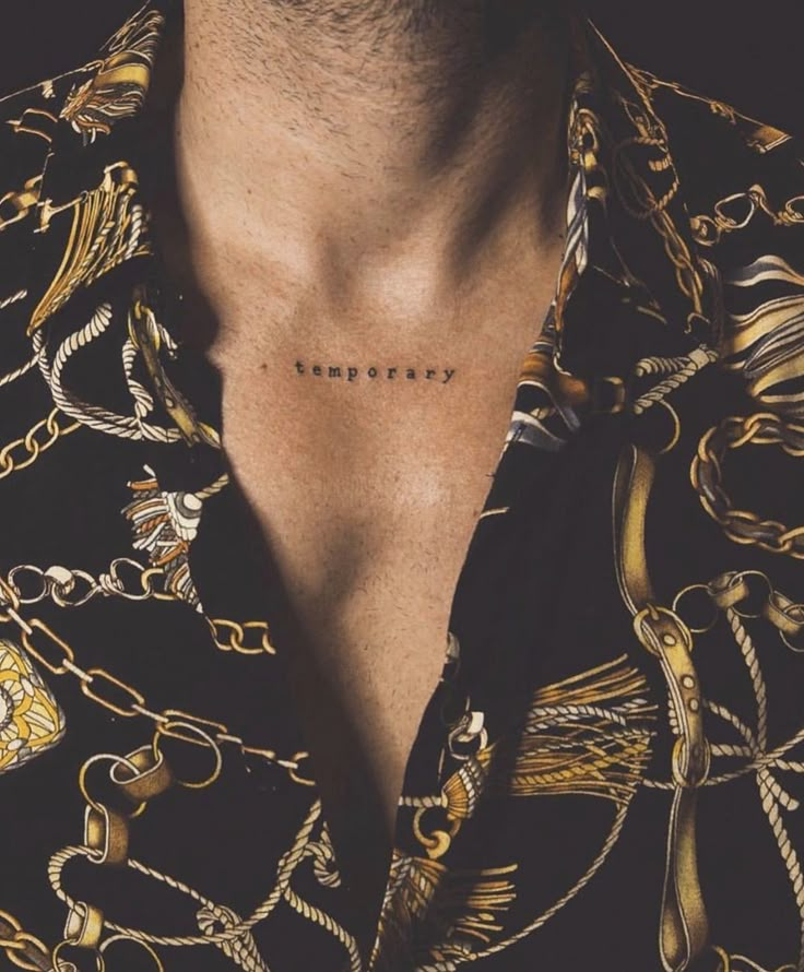 a man wearing a black shirt with gold chains on his chest and the word instagram written