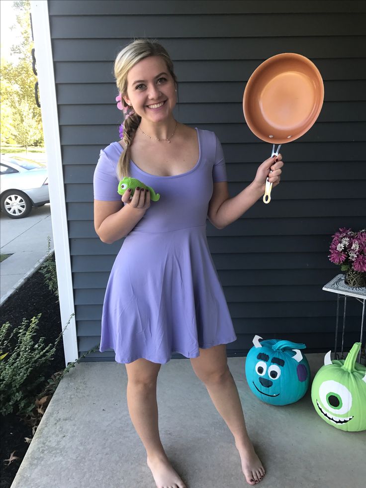 a woman in a purple dress is holding a frying pan and an eggplant