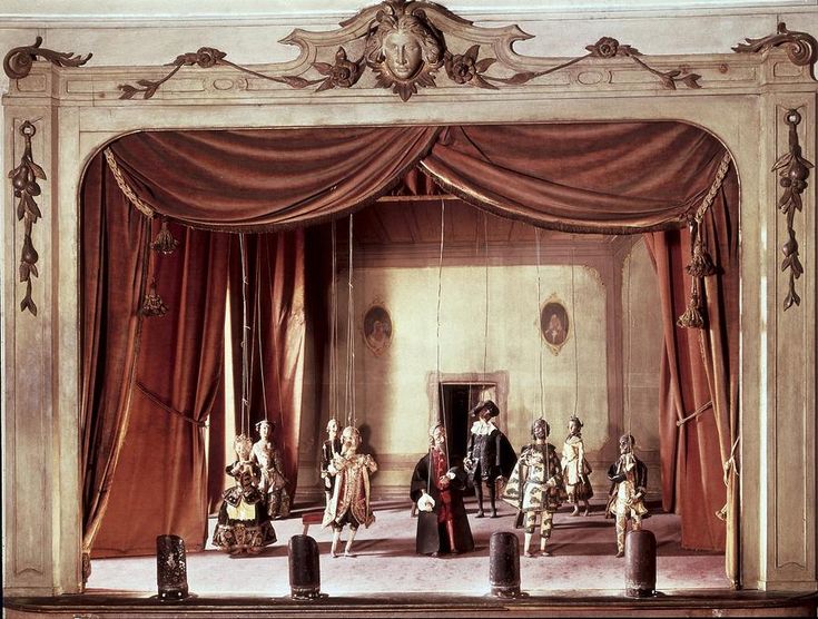 the stage is set for a play with people dressed in fancy clothing and costumes,