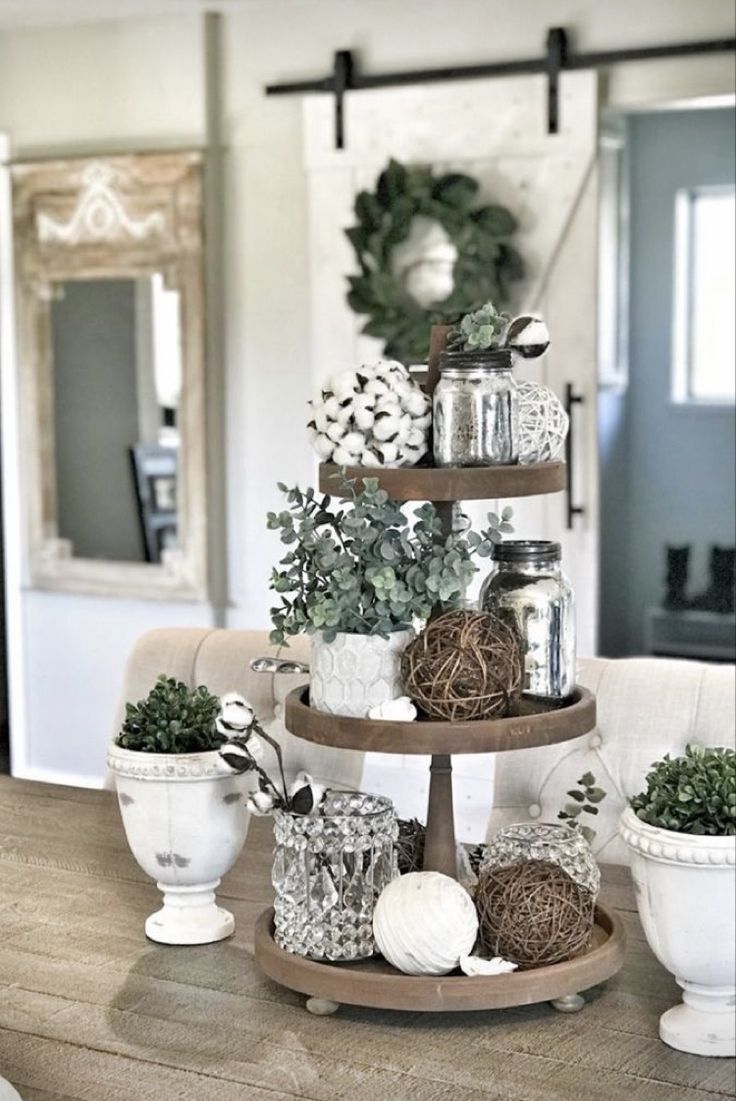 three tiered trays filled with plants on top of a wooden table