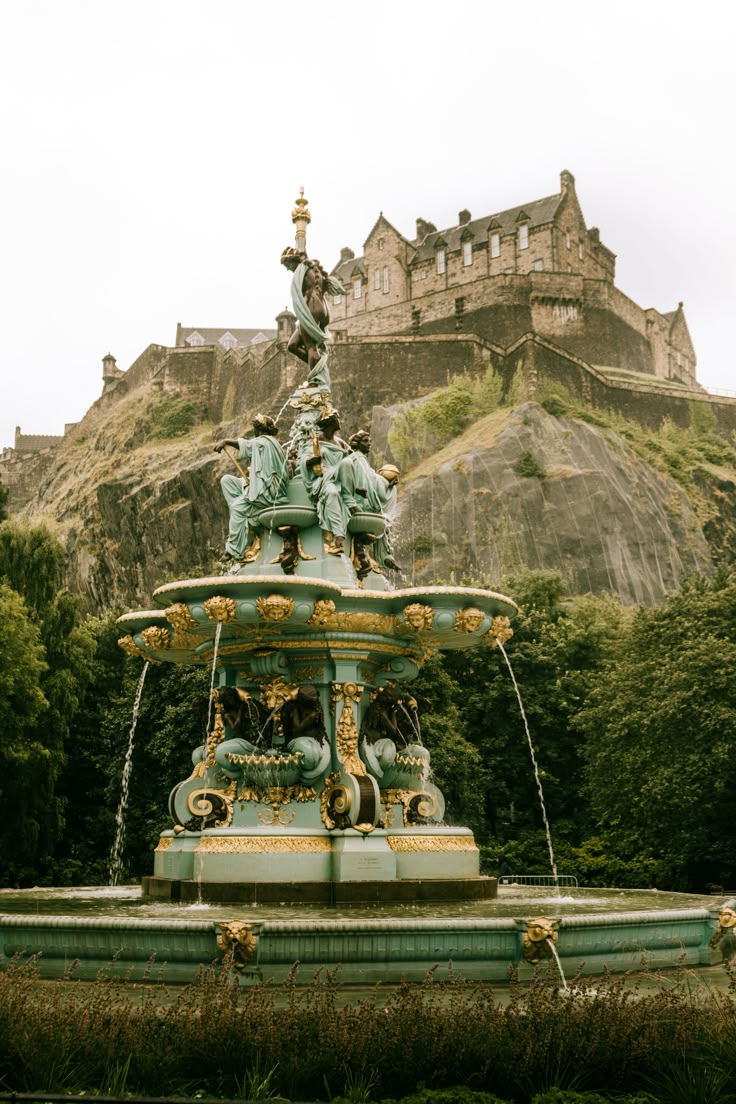 an ornate fountain in front of a castle