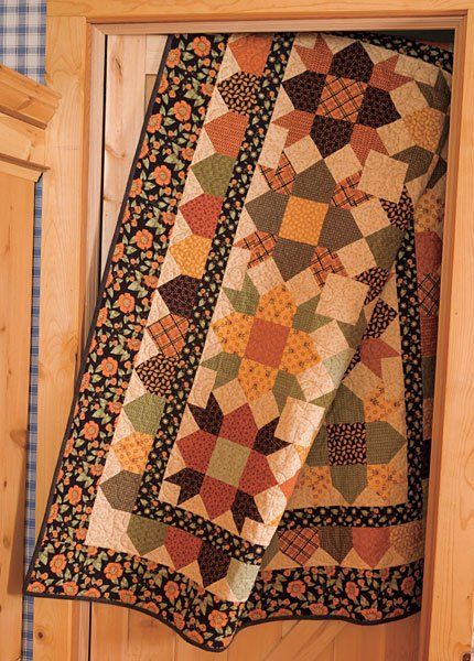 a quilt hanging from the side of a cabinet