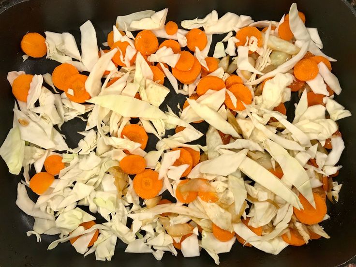 chopped carrots and cabbage cooking in a skillet