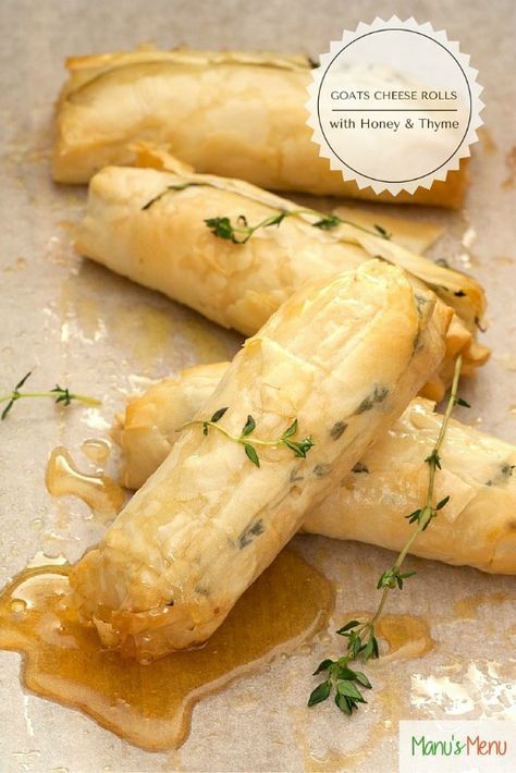 some food is sitting on a table with a label over it that says garlic cheese rolls with honey and thym