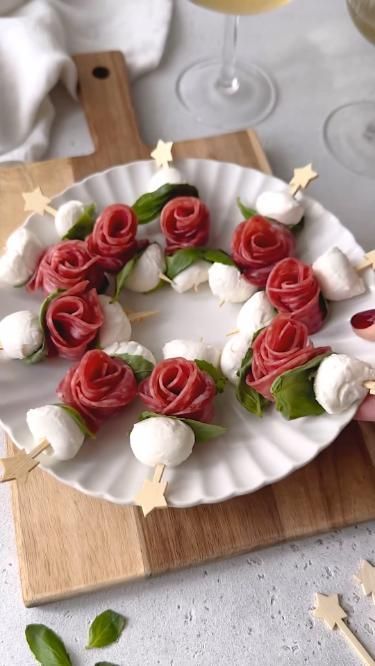 a white plate topped with red roses and marshmallows