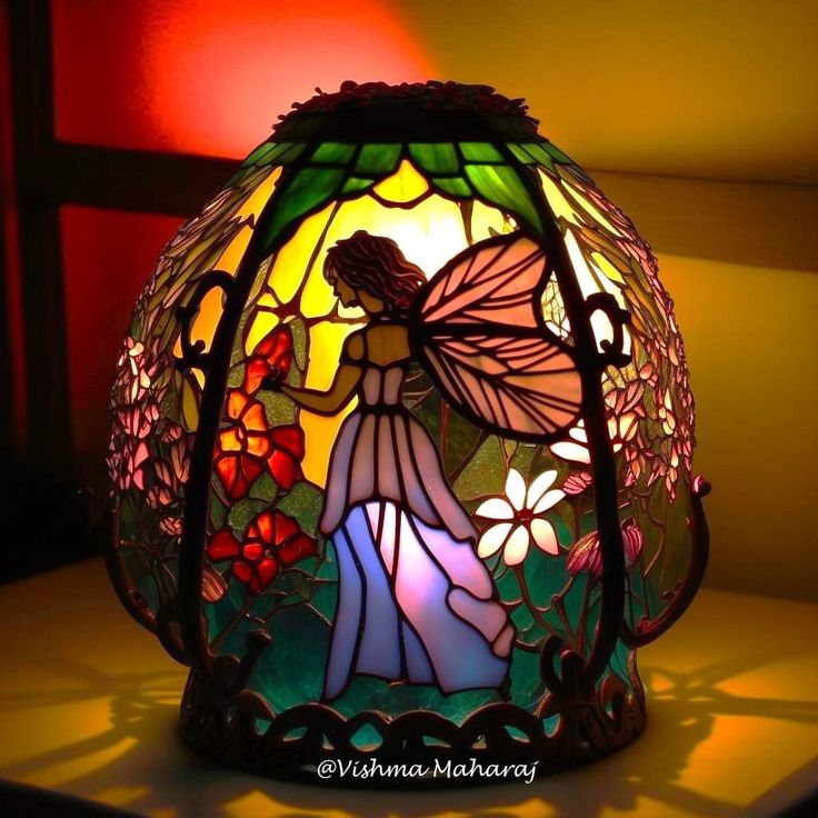 a stained glass lamp sitting on top of a table