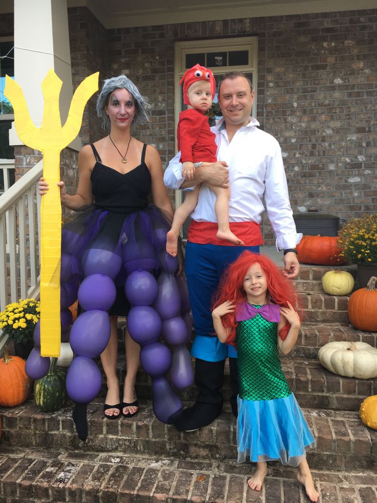 the family is dressed up for halloween outside