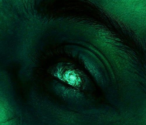 a close up view of an eye with green light