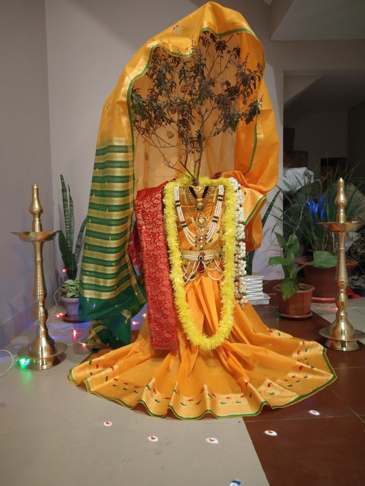 an idol is sitting on the floor next to some candles and other decorations in front of it