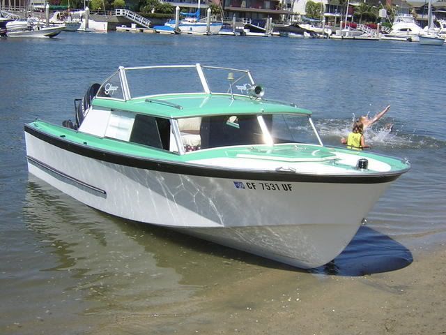 a small white and green boat in the water