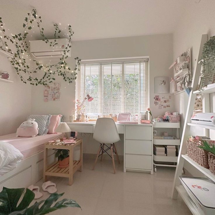 a bedroom with white furniture and lots of plants in the window sill, next to a bed