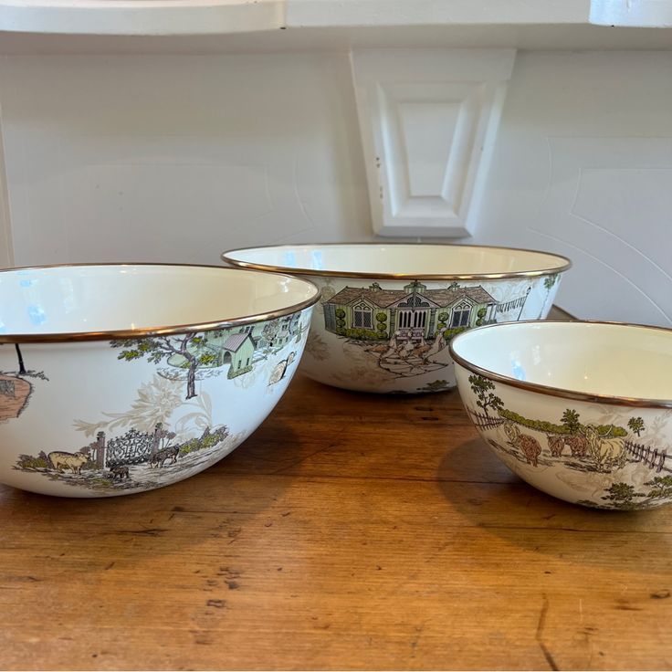 three bowls sitting on top of a wooden table