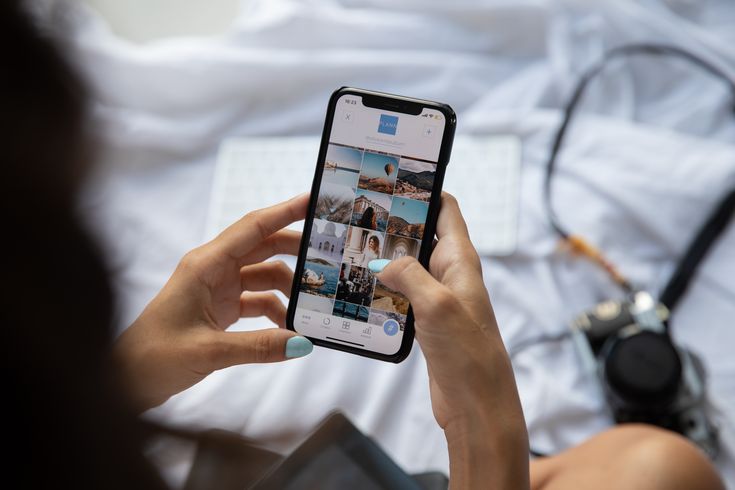 a woman is holding up her cell phone to take a selfie with the camera