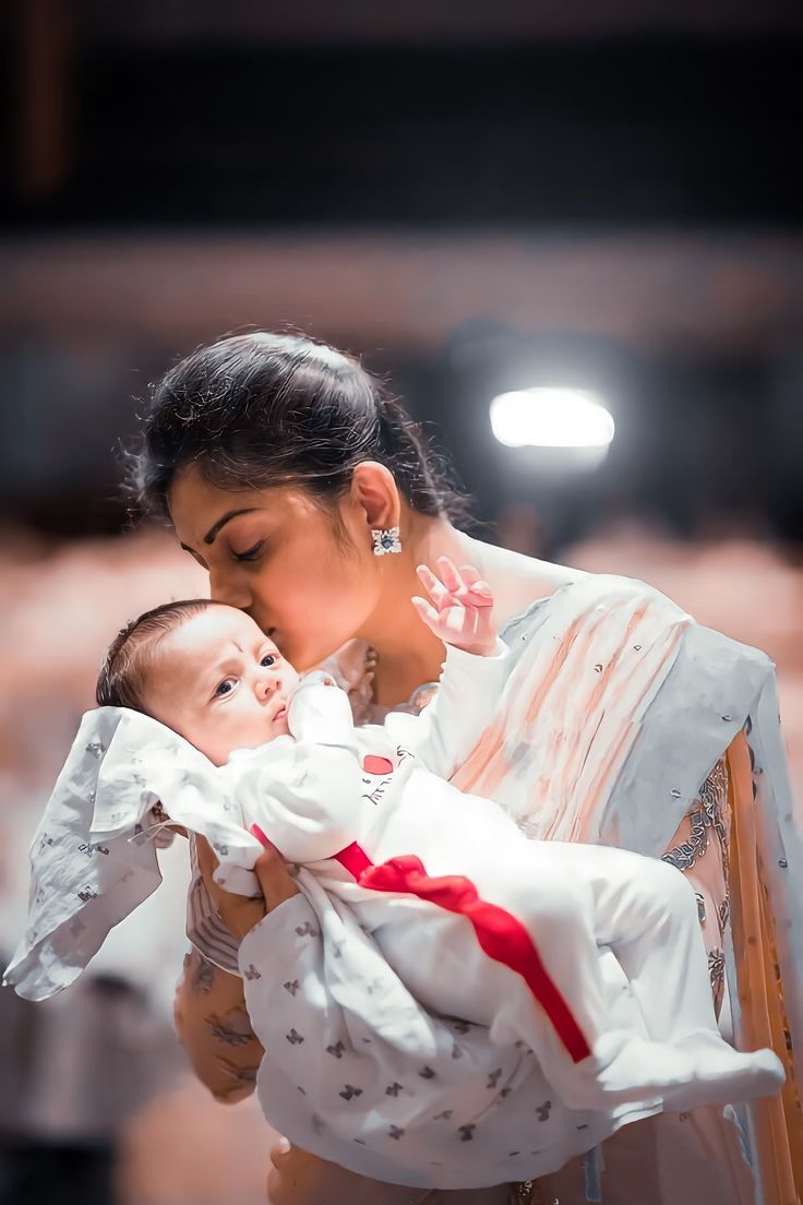 a woman holding a baby in her arms