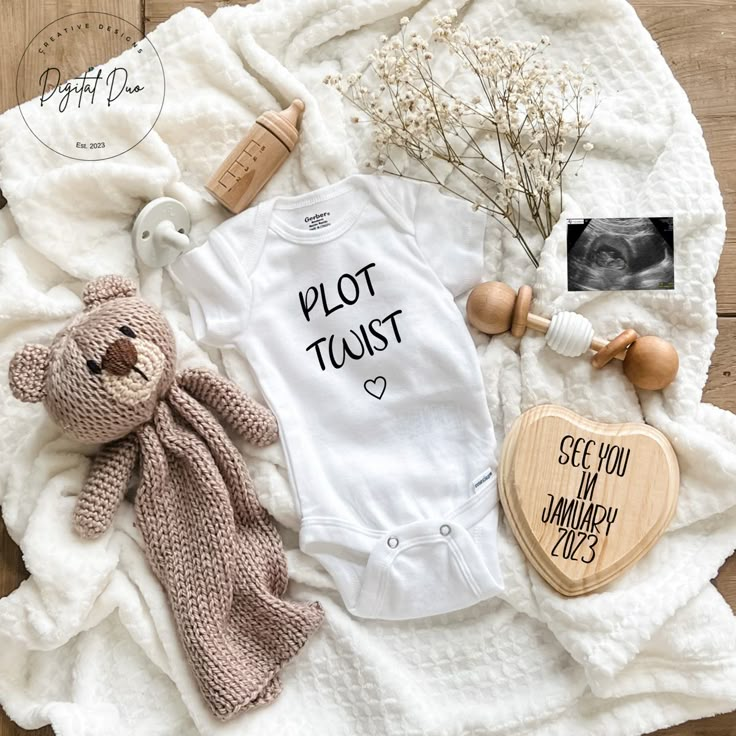 a baby's first birthday outfit and other items laid out on top of a blanket