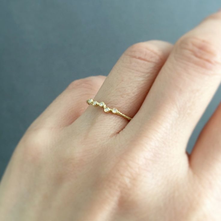 a woman's hand with a diamond ring on it