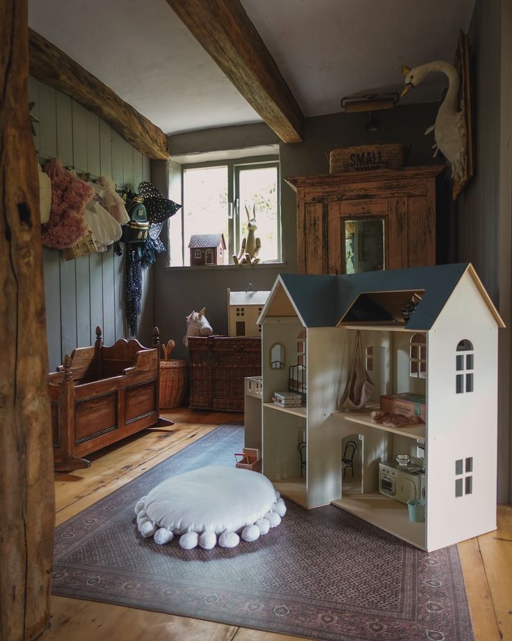 a doll house sitting on top of a rug in a living room next to a window