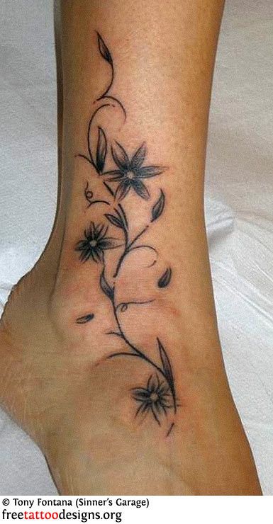 a woman's foot with a flower tattoo on it