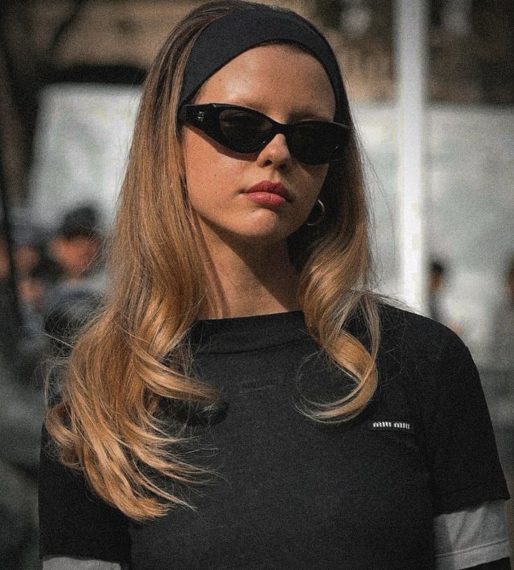 a woman wearing sunglasses and a black shirt