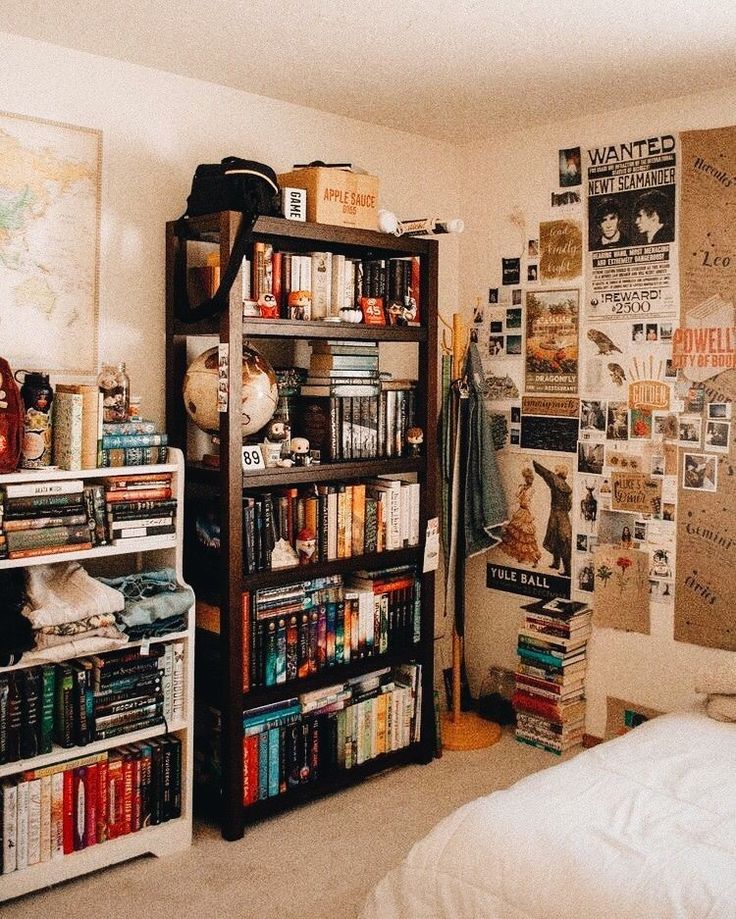 a bedroom filled with lots of books and pictures on the wall next to a bed