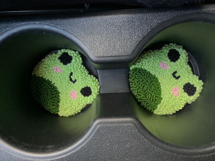 two cupcakes shaped like broccoli sitting on top of each other in a muffin tin