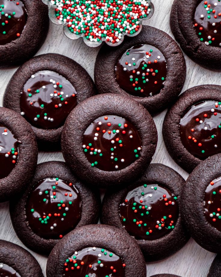 cookies with chocolate frosting and sprinkles on a table