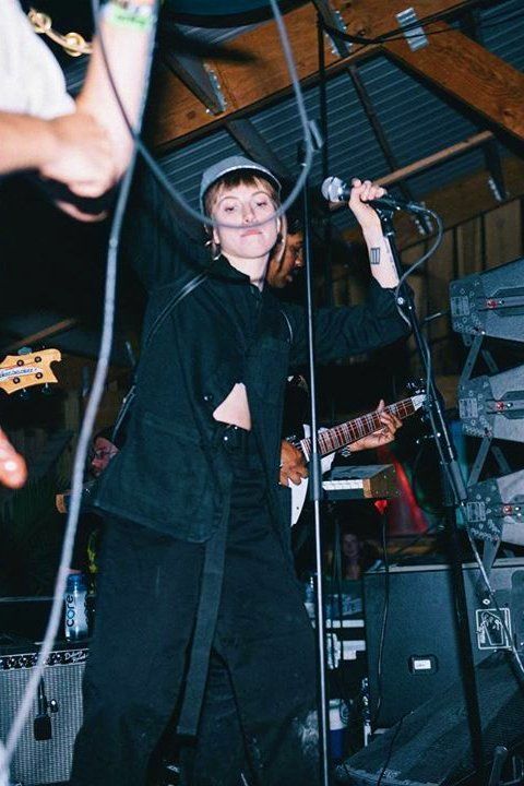 a woman standing on top of a stage holding a microphone