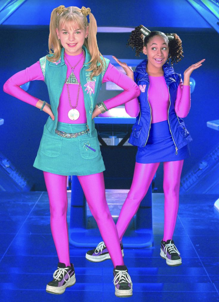 two girls dressed in pink and green posing for the camera with their hands on their hipss