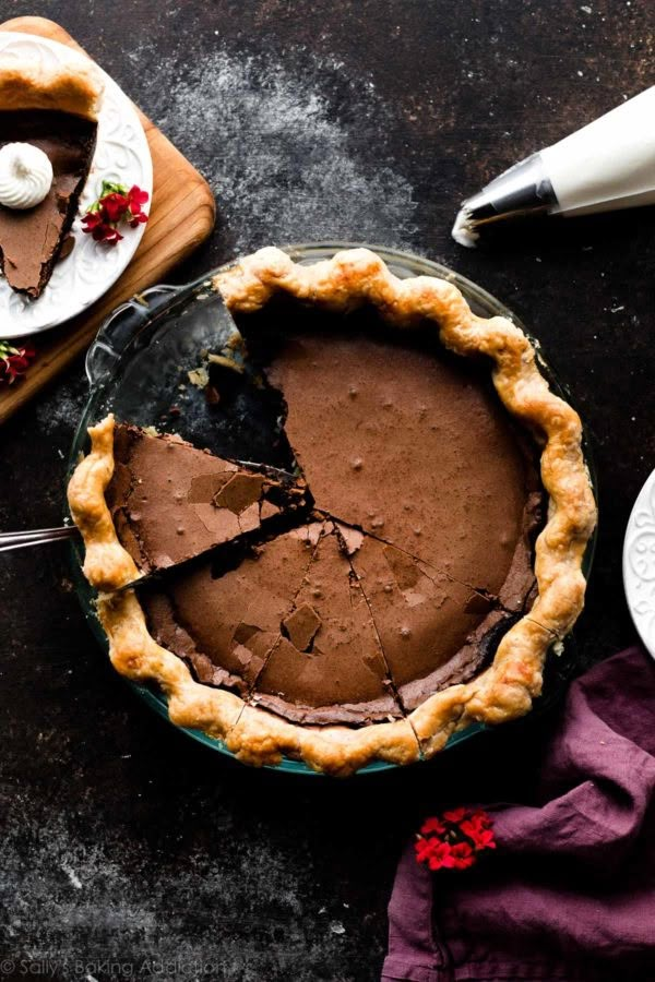 a chocolate pie with one slice missing from it