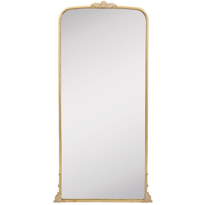 an ornate gold framed mirror against a white background