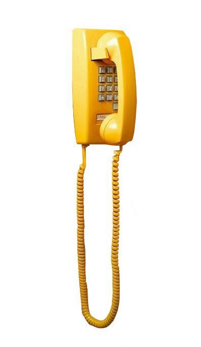 an old fashioned yellow telephone on a white background