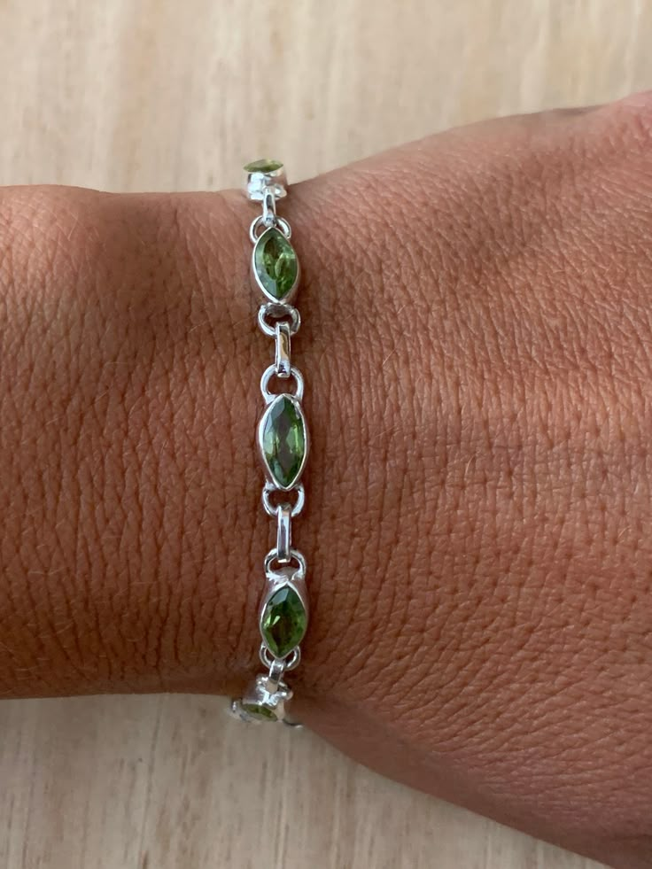 Lovely faceted peridot and sterling silver bracelet. The bracelet has 10 individual faceted peridot stones in marquise shape.  The bracelet measure 19.5 cm long and it is almost 0.5 cm wide. The bracelet can be  easily  adjusted from 19.5 cm to 18.5 cm.  The high quality of our stones is what it makes this bracelet so precious. The peridot is faceted to add the extra shining and elegance to the bracelet.  A perfect present for her on any occasion St Valentine Day, Birthday, Anniversary, or Chris Peridot Bracelet, Piercings Jewelry, Dope Jewelry, August Birthstone, Bracelet Chain, Funky Jewelry, Green Peridot, Jewelry Lookbook, Mens Accessories Jewelry