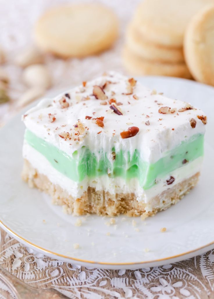 a piece of cake sitting on top of a white plate next to cookies and crackers