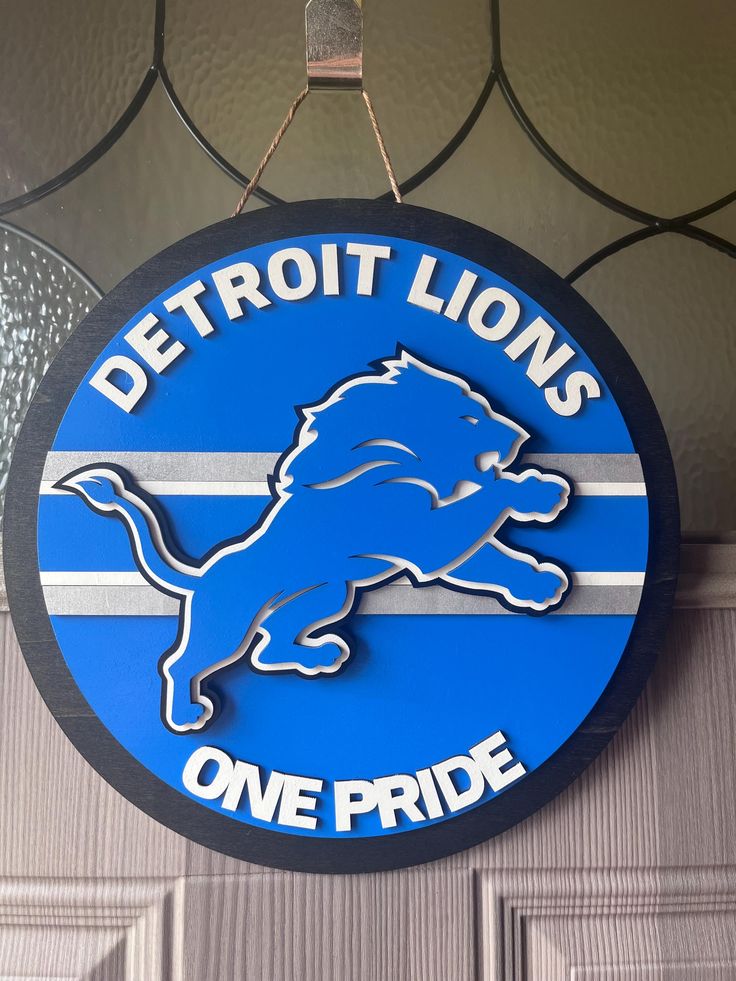 detroit lions one pride sign hanging on the door