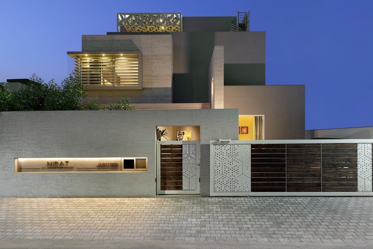 a modern house is lit up at night