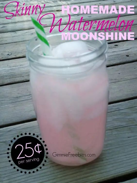 a mason jar filled with pink liquid and a green straw