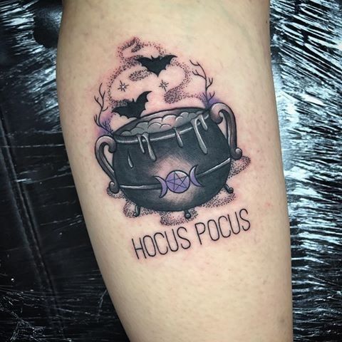 a black and white tattoo with the words hocus pocus on it