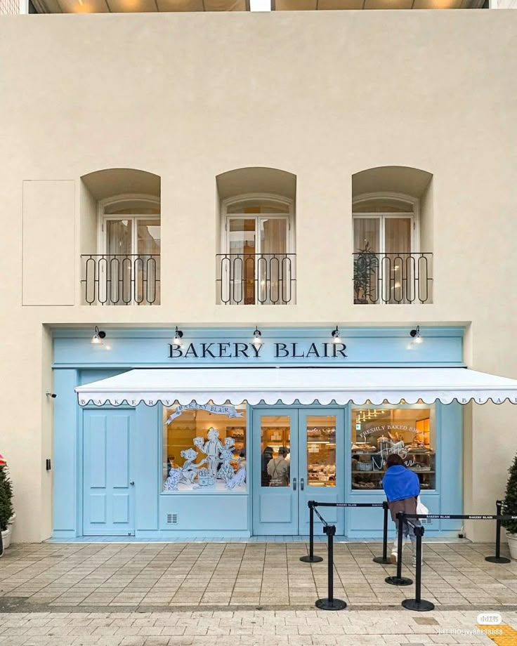 a store front with blue doors and windows