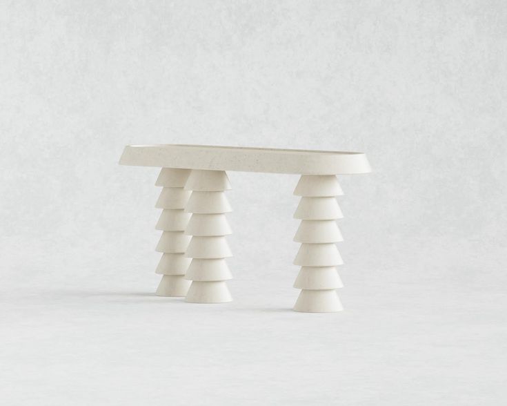 a white table sitting on top of a white floor